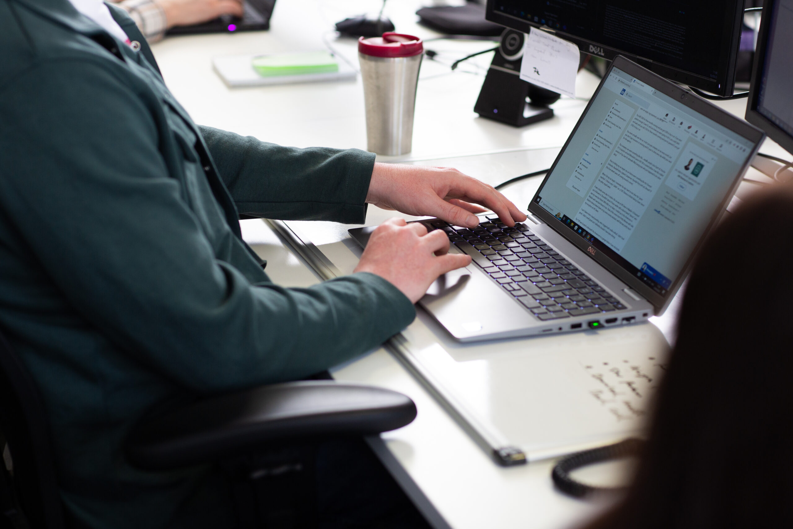 Office worker typing on laptop