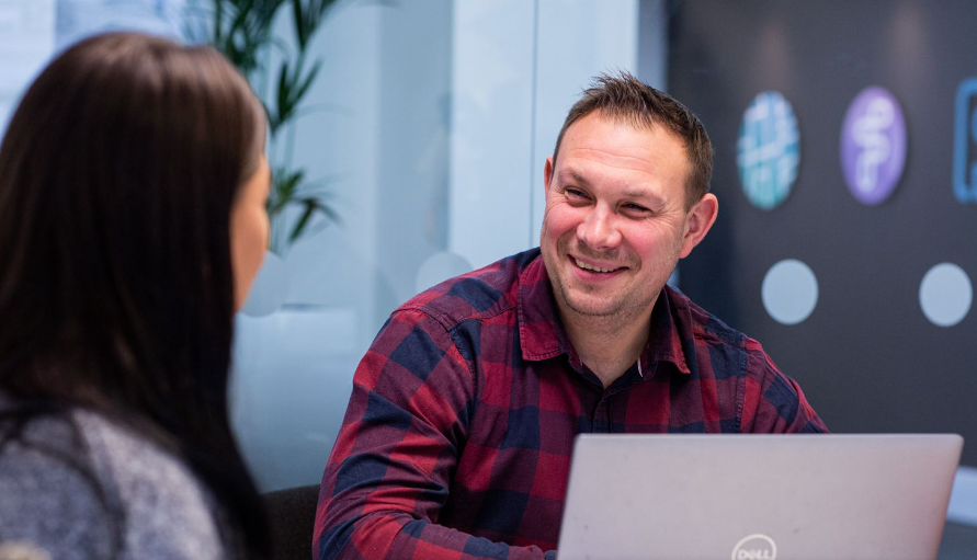 tech recruiter smiling at colleague